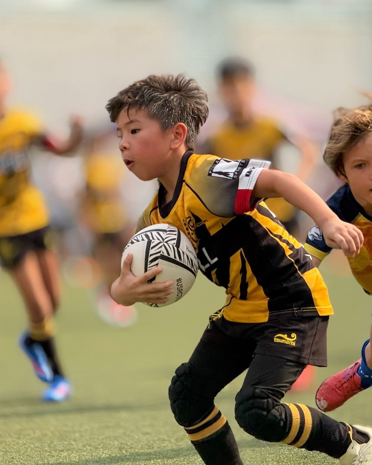 USRC Tigers mini rugby players in tiger-stripe kit